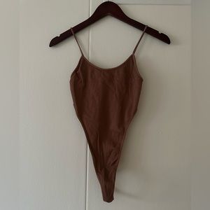 Boutique deep side cut bodysuit